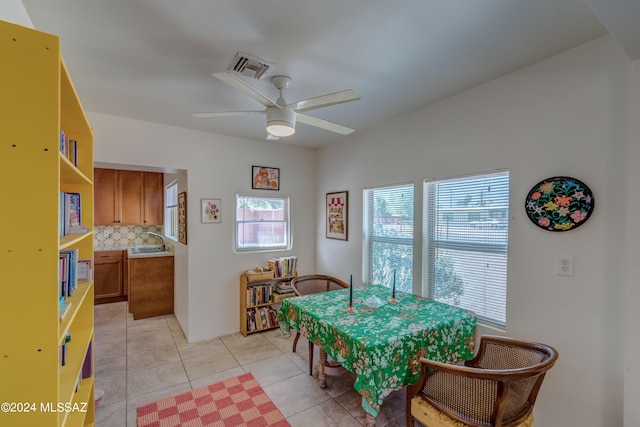 dining room with ceiling fan, sink, and light tile patterned flooring