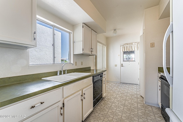 kitchen with white cabinets, dishwasher, light tile patterned floors, white refrigerator, and sink