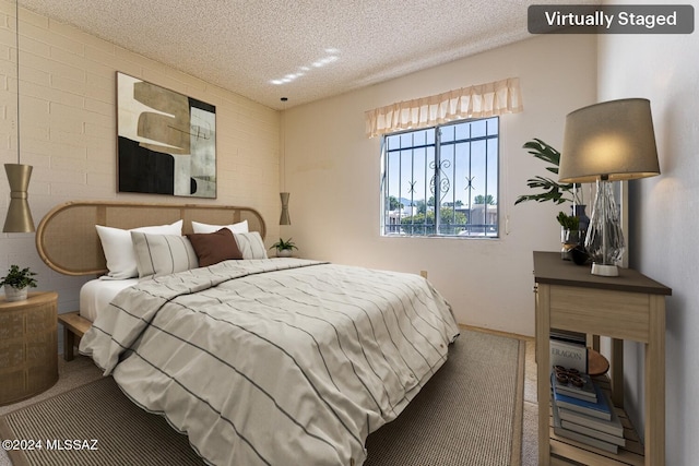 bedroom with a textured ceiling and carpet flooring