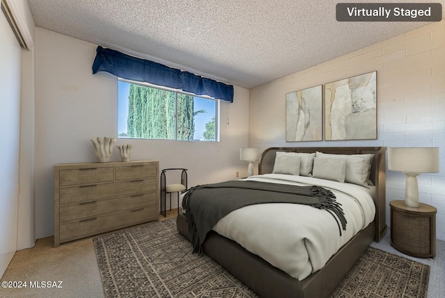 bedroom featuring a textured ceiling and carpet floors