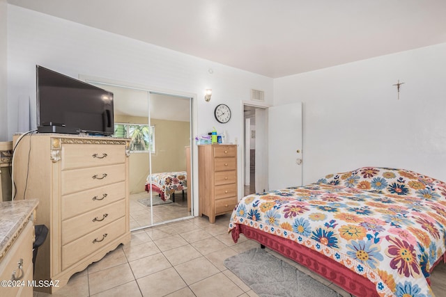 tiled bedroom featuring a closet