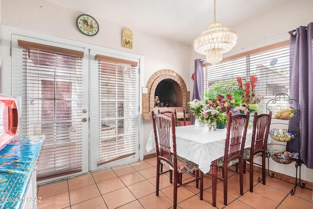 tiled dining room featuring a notable chandelier