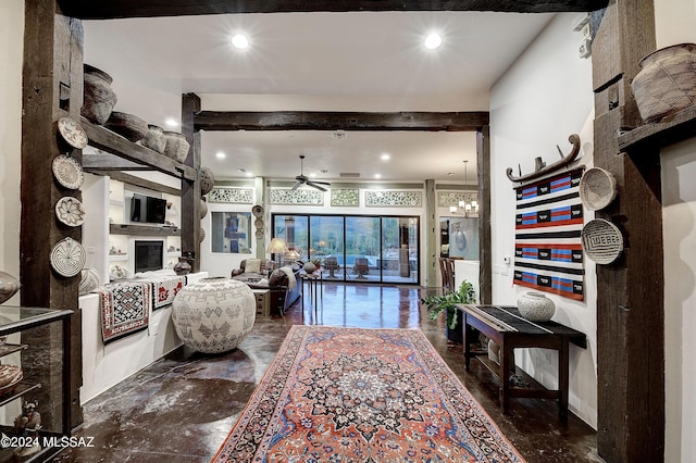 living area featuring recessed lighting, a fireplace, and ceiling fan with notable chandelier