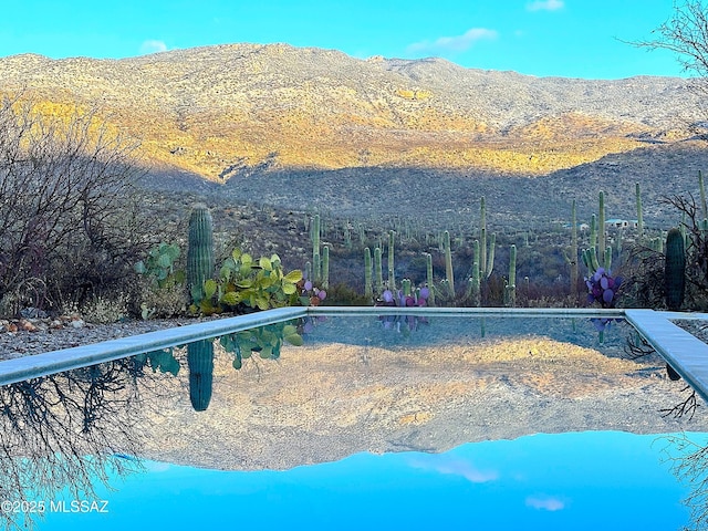 view of swimming pool featuring a mountain view