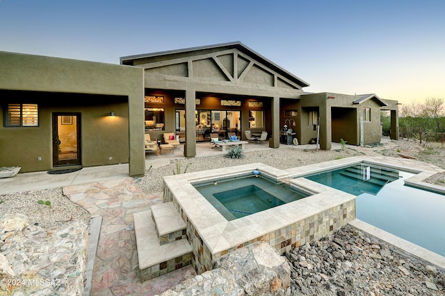 back of house with a patio, stucco siding, a fenced in pool, and an in ground hot tub