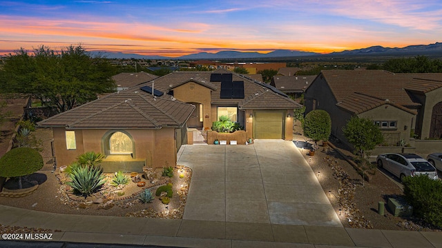 view of front of property featuring a garage and a mountain view