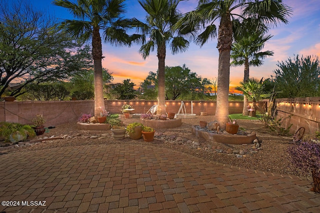 view of patio terrace at dusk