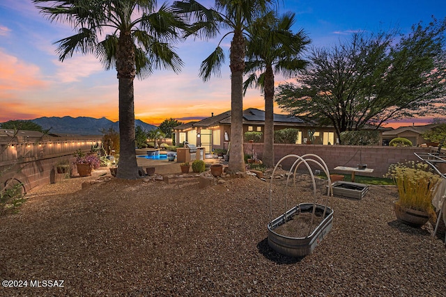 exterior space featuring a mountain view and a fenced in pool