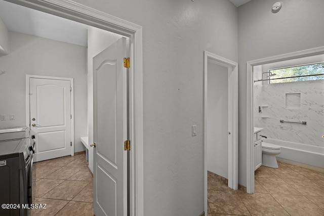 bathroom featuring a bathtub, tile patterned floors, vanity, and toilet