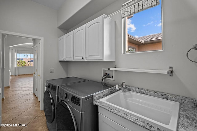 laundry area featuring light tile patterned flooring, plenty of natural light, separate washer and dryer, and sink