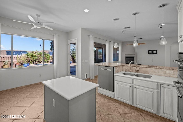 kitchen with an island with sink, white cabinets, sink, and stainless steel dishwasher