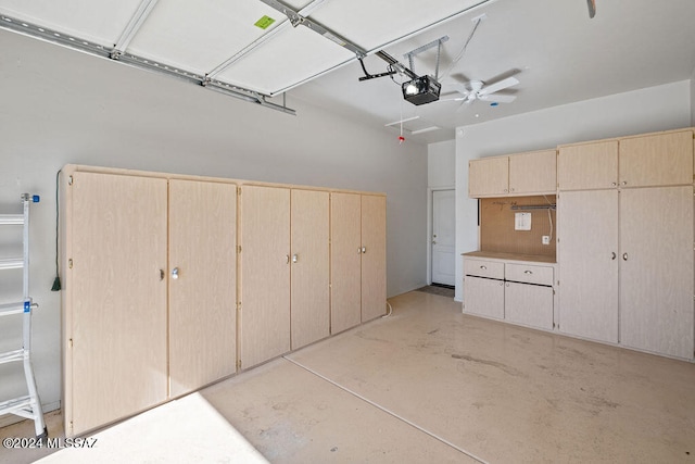 garage with a garage door opener and ceiling fan