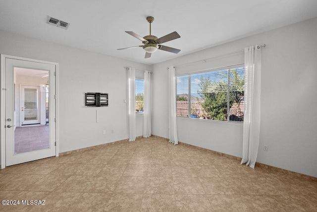 unfurnished room featuring light tile patterned flooring and ceiling fan