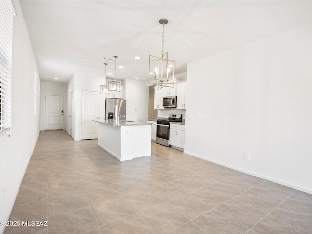 kitchen with a kitchen island with sink, recessed lighting, white cabinets, a notable chandelier, and stainless steel appliances