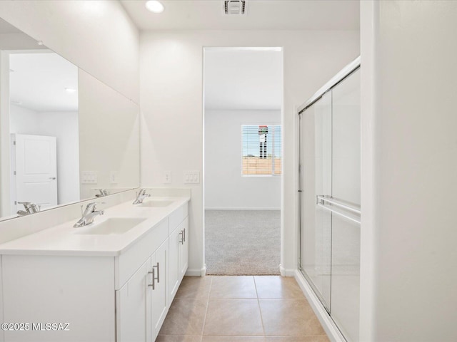 full bathroom featuring a sink, tile patterned flooring, a stall shower, and visible vents