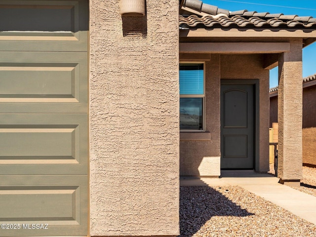 entrance to property featuring stucco siding