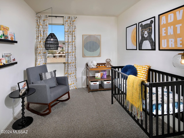 carpeted bedroom with a nursery area and baseboards