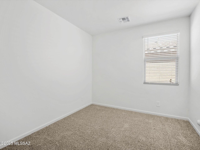carpeted empty room with baseboards and visible vents