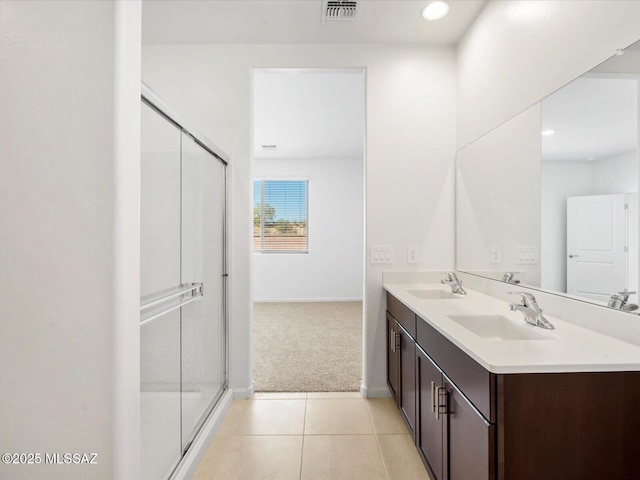 full bathroom featuring a sink, tile patterned floors, a stall shower, and visible vents