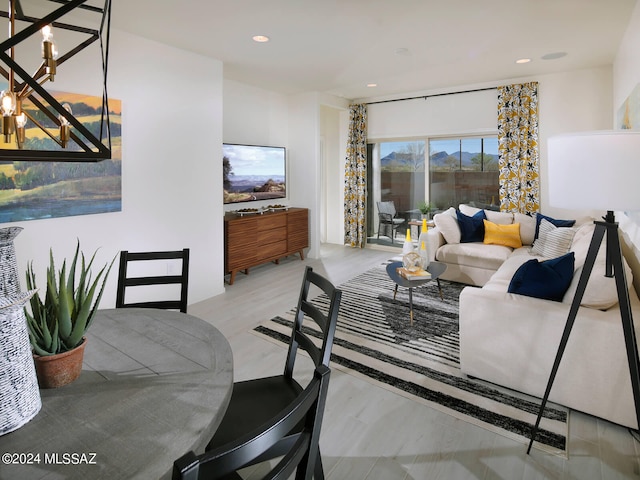 living room featuring recessed lighting and a notable chandelier