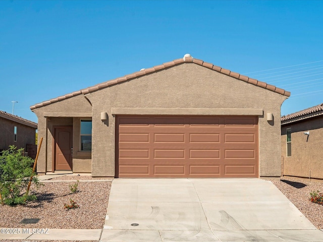 view of front of house featuring a garage, stucco siding, and driveway