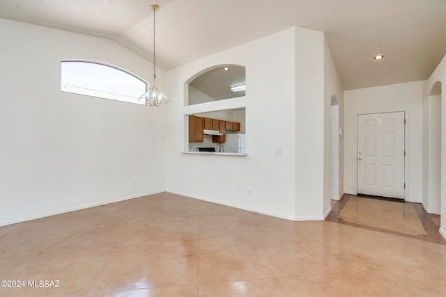 interior space with lofted ceiling and a notable chandelier