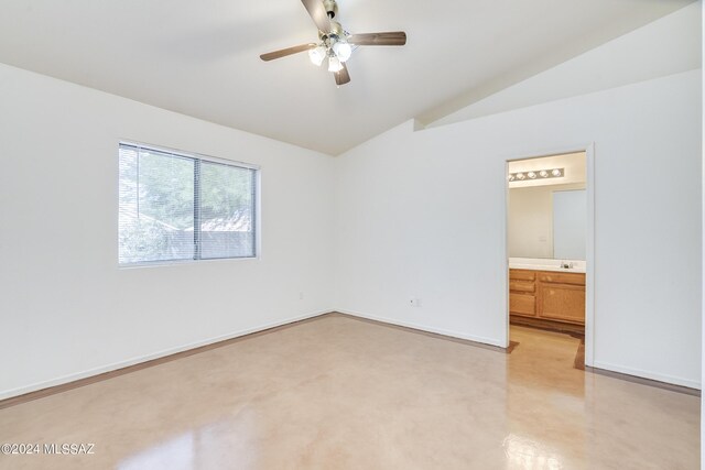 unfurnished room featuring lofted ceiling, ceiling fan, and sink