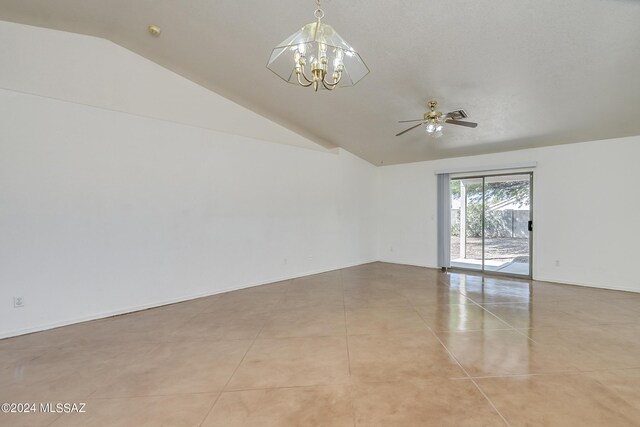 tiled empty room featuring ceiling fan with notable chandelier and lofted ceiling