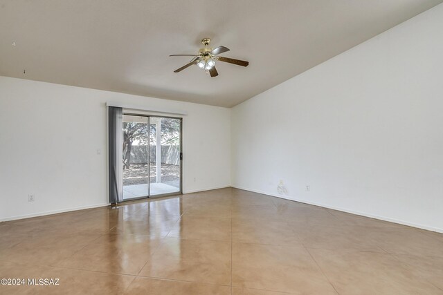 spare room with ceiling fan and light tile patterned flooring