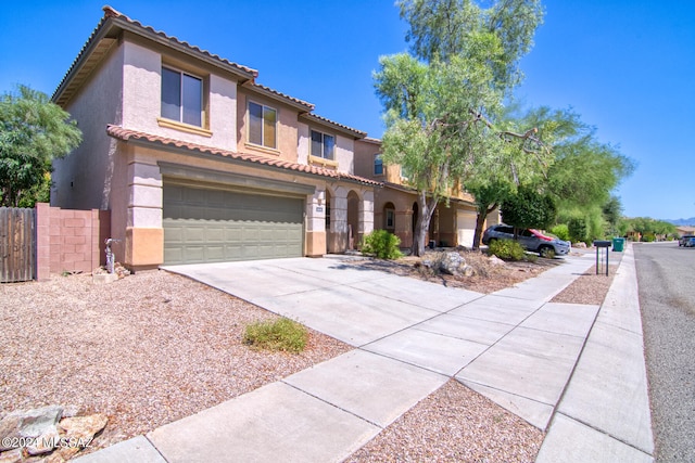 mediterranean / spanish-style home with a garage