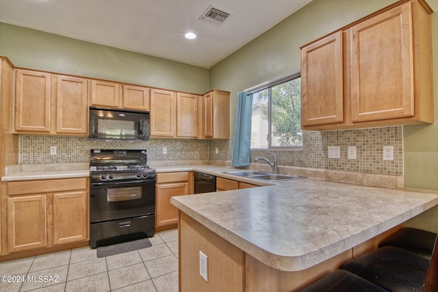 kitchen featuring black appliances, light brown cabinets, kitchen peninsula, and sink