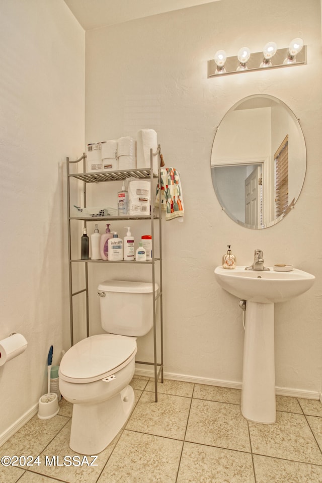 bathroom featuring tile patterned flooring, toilet, and sink