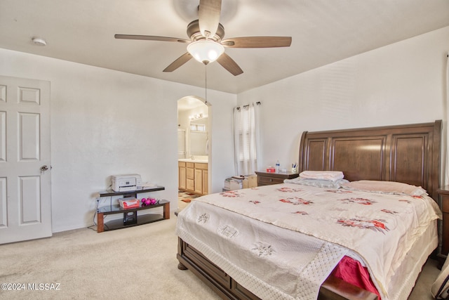 carpeted bedroom featuring ensuite bathroom and ceiling fan