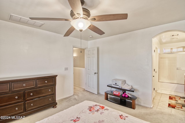 carpeted bedroom featuring connected bathroom and ceiling fan