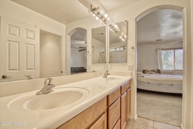 bathroom featuring tile patterned flooring, vanity, and ceiling fan