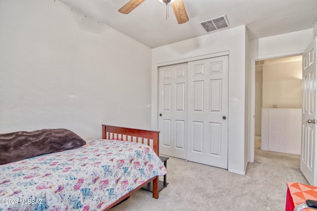 bedroom with a closet, light carpet, and ceiling fan