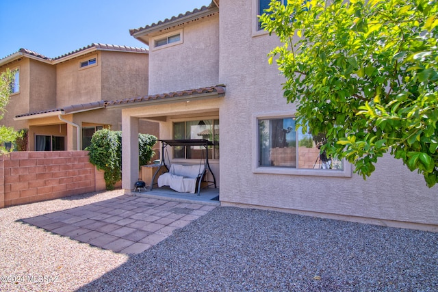 back of house with a patio