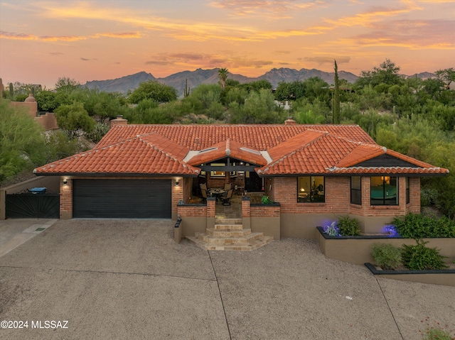 view of front of home featuring a mountain view and a garage