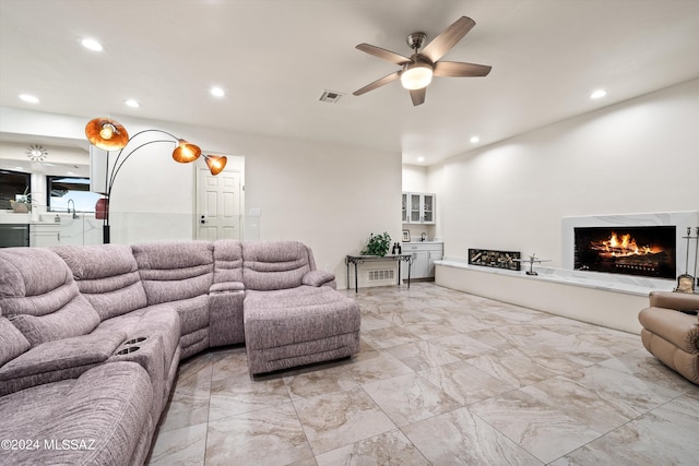 living room featuring visible vents, recessed lighting, a high end fireplace, ceiling fan, and marble finish floor
