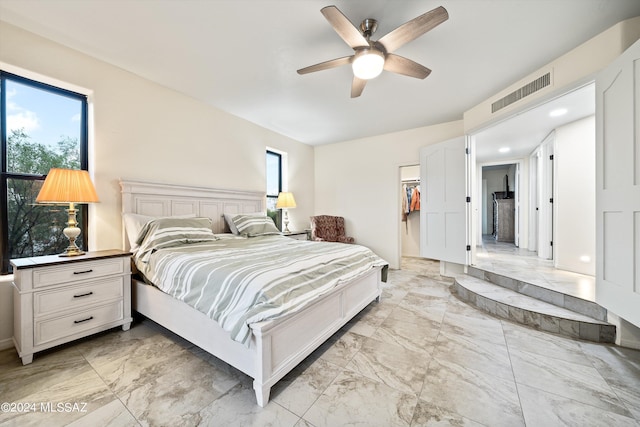 bedroom featuring multiple windows, visible vents, marble finish floor, and ceiling fan