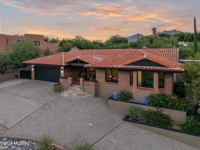 view of front of home featuring a mountain view and a garage