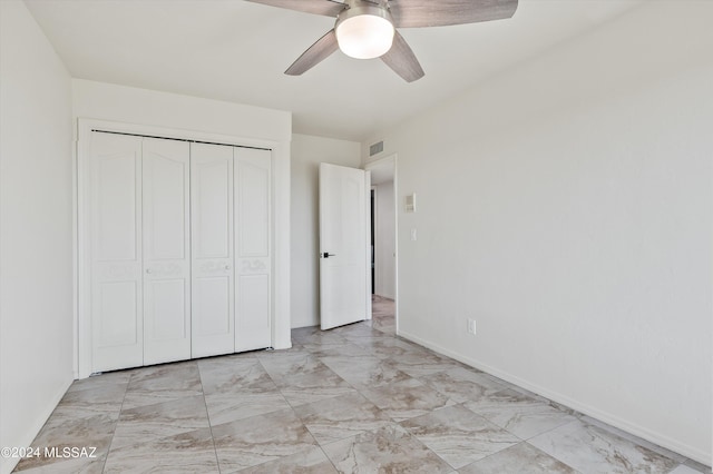unfurnished bedroom featuring a closet, visible vents, baseboards, and ceiling fan