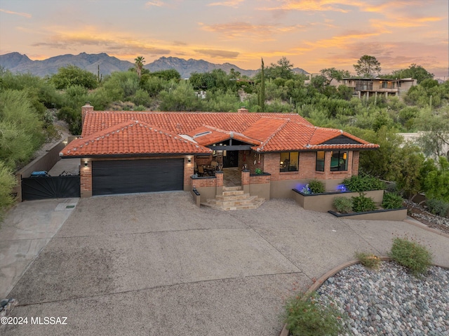 view of front of home featuring a mountain view and a garage