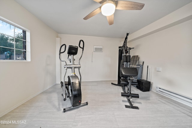 exercise room with a baseboard radiator, an AC wall unit, and ceiling fan