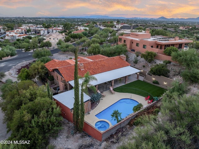 aerial view at dusk featuring a mountain view