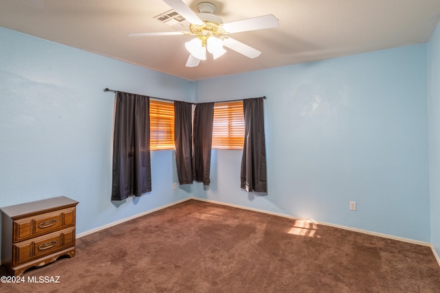 spare room featuring ceiling fan and carpet floors