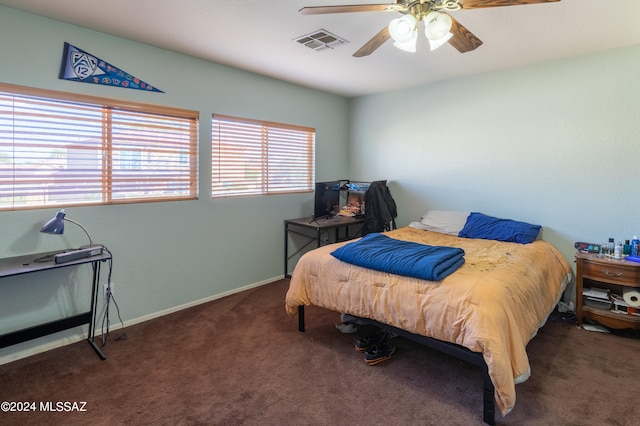 bedroom with dark colored carpet and ceiling fan