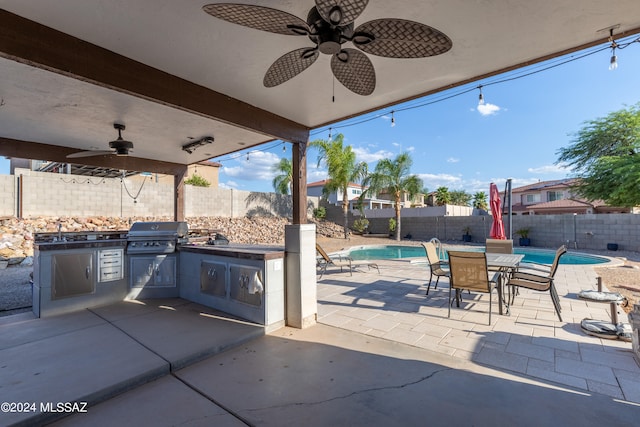 view of patio / terrace with a grill, ceiling fan, exterior kitchen, and a fenced in pool