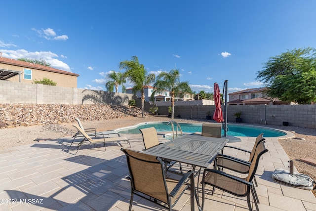 view of patio / terrace with a fenced in pool