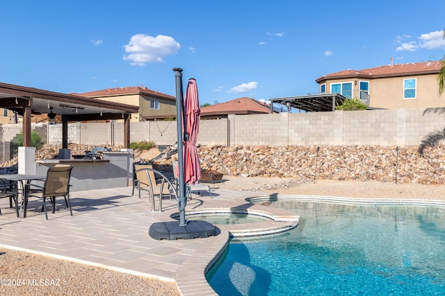 view of swimming pool featuring a bar and a patio area